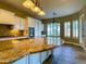 Chef's kitchen with large island, granite countertops, and custom lighting at 3840 E San Mateo Way, Chandler, AZ 85249