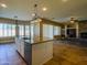 Modern kitchen island with granite countertops, stainless steel appliances, and views of the living room at 3840 E San Mateo Way, Chandler, AZ 85249
