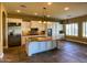 Open kitchen with large island, stainless steel fridge, and ample natural light at 3840 E San Mateo Way, Chandler, AZ 85249