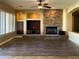 Spacious living room features a stone fireplace, built-in cabinets, modern ceiling fan, and natural light at 3840 E San Mateo Way, Chandler, AZ 85249
