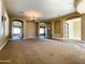 Open-concept living area with plush carpet, elegant lighting, and seamless flow to the kitchen at 3840 E San Mateo Way, Chandler, AZ 85249