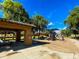 Community playground with a covered picnic area, slides, and swings surrounded by mature trees at 3840 E San Mateo Way, Chandler, AZ 85249