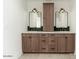 Stylish bathroom with double sink vanity, wood cabinets, and modern lighting fixtures at 3913 E Campbell Ave, Phoenix, AZ 85018