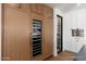 A gorgeous kitchen with white cabinets, a wine cooler, stainless steel appliances, and hardwood floors at 3913 E Campbell Ave, Phoenix, AZ 85018