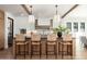 Bright kitchen with a large island, pendant lighting, hardwood floors, white cabinets, and seating for four at 3913 E Campbell Ave, Phoenix, AZ 85018