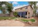 Expansive backyard featuring lush grass, pavers, mature trees, covered patio and desert landscaping at 4254 S Winter Ln, Gilbert, AZ 85297
