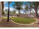 Grassy backyard with trees, stone accents, brick border, and a stone fireplace at 4254 S Winter Ln, Gilbert, AZ 85297
