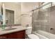 Bathroom featuring a glass shower, vanity with dark cabinets and a neutral countertop at 4254 S Winter Ln, Gilbert, AZ 85297