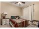 Comfortable bedroom with a ceiling fan, carpet, and a patterned bedspread at 4254 S Winter Ln, Gilbert, AZ 85297