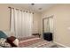 Bedroom featuring a mirrored closet, carpet, and modern window coverings at 4254 S Winter Ln, Gilbert, AZ 85297