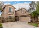 Two-story home features a three car garage, desert landscaping, and a charming balcony at 4254 S Winter Ln, Gilbert, AZ 85297