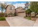 Two-story home features a three car garage, desert landscaping, and a charming balcony at 4254 S Winter Ln, Gilbert, AZ 85297