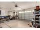 Spacious garage with a door, shelving, and bikes offering ample storage and functionality at 4254 S Winter Ln, Gilbert, AZ 85297