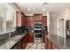 Well-appointed kitchen features dark cabinets, granite countertops, stainless appliances, and ample space at 4254 S Winter Ln, Gilbert, AZ 85297