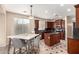 Eat-in kitchen with dark cabinetry, granite countertops, stainless appliances, and large marble table at 4254 S Winter Ln, Gilbert, AZ 85297