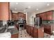 Gourmet kitchen equipped with dark cabinets, granite counters, stainless appliances, and center island at 4254 S Winter Ln, Gilbert, AZ 85297