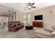 Spacious living room featuring neutral walls, plush carpet, and comfortable brown leather seating at 4254 S Winter Ln, Gilbert, AZ 85297