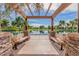 Picturesque pergola overlooking a tranquil pond with benches at 4254 S Winter Ln, Gilbert, AZ 85297