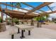 Community playground featuring shade structures, picnic tables and playground equipment in a park setting at 4254 S Winter Ln, Gilbert, AZ 85297