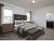 Main bedroom featuring a spacious layout, two windows, and en-suite bathroom at 47165 W Coe St, Maricopa, AZ 85139
