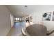 Open-concept dining area leading into kitchen and living room with tiled floors at 47165 W Coe St, Maricopa, AZ 85139