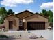 Charming single-story home featuring a two-car garage, desert landscaping, and a welcoming front entrance at 47165 W Coe St, Maricopa, AZ 85139