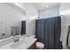 Stylish bathroom with a single sink vanity, framed mirror, and shower with a privacy curtain at 5429 W Chuck Box Rd, Laveen, AZ 85339