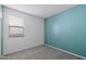 Bright bedroom with a modern accent wall, plush carpeting, and a window letting in natural light at 5429 W Chuck Box Rd, Laveen, AZ 85339