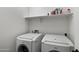 Functional laundry room equipped with matching Bosch washer and dryer beneath a shelf at 5429 W Chuck Box Rd, Laveen, AZ 85339