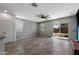 Spacious living area with tile flooring, a ceiling fan, and a sliding glass door to the backyard at 5429 W Chuck Box Rd, Laveen, AZ 85339