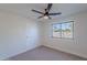 Neutral bedroom with a ceiling fan, a window providing natural light, and a closet for storage at 5525 E Waltann Ln, Scottsdale, AZ 85254
