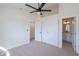 Bedroom with a ceiling fan, closet and a doorway to the bathroom, offering convenience and functionality at 5525 E Waltann Ln, Scottsdale, AZ 85254