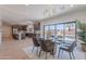 Dining room with glass table, modern chandelier and view of the kitchen and pool at 5525 E Waltann Ln, Scottsdale, AZ 85254