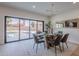 Dining room with glass table, modern chandelier and view of the backyard pool at 5525 E Waltann Ln, Scottsdale, AZ 85254
