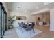 Bright dining room with hardwood floors, glass table and view into the living room at 5525 E Waltann Ln, Scottsdale, AZ 85254