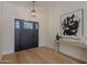 Spacious entry way with hardwood floors, artwork and a front door with sidelights at 5525 E Waltann Ln, Scottsdale, AZ 85254