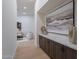 Elegant hallway featuring wood floors, a built-in cabinet with decor, and an open view to a sitting area at 5525 E Waltann Ln, Scottsdale, AZ 85254