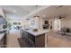Open kitchen with large island, stainless steel appliances, breakfast bar, and flows into living areas at 5525 E Waltann Ln, Scottsdale, AZ 85254