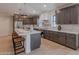Modern kitchen with a large island, stainless steel appliances, breakfast bar, and ample cabinet space at 5525 E Waltann Ln, Scottsdale, AZ 85254