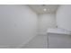 Well-lit laundry room with patterned tile floors, a countertop, and clean white walls at 5525 E Waltann Ln, Scottsdale, AZ 85254