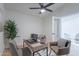 Bright home office with a ceiling fan, a modern desk setup, and a view through a glass door at 5525 E Waltann Ln, Scottsdale, AZ 85254
