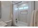 Bathroom featuring a tub-shower combo with bright tile, a built-in niche, bronze fixtures and a shower curtain at 5525 E Waltann Ln, Scottsdale, AZ 85254