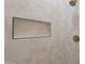 Modern shower featuring tiled walls, rainfall shower head, and built-in niche for storage at 5525 E Waltann Ln, Scottsdale, AZ 85254