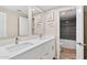 Bright bathroom featuring double vanity with quartz countertop and modern faucets at 5833 N 10Th St, Phoenix, AZ 85014