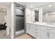 Bathroom featuring double vanity with modern sinks and a walk-in shower with gray tiling at 5833 N 10Th St, Phoenix, AZ 85014