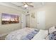 Bedroom featuring a TV, ceiling fan, and natural light from a window and a connecting door at 5833 N 10Th St, Phoenix, AZ 85014