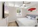 Bedroom featuring neutral carpet, ceiling fan, and a bright window for plenty of natural light at 5833 N 10Th St, Phoenix, AZ 85014