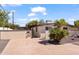 Tan-colored home exterior with a landscaped yard and gray trim around the windows at 5833 N 10Th St, Phoenix, AZ 85014