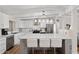 Modern kitchen featuring a large island with seating, stainless steel appliances, and white cabinetry at 5833 N 10Th St, Phoenix, AZ 85014