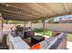 Cozy covered patio with comfortable seating, fire pit, string lights, and barbecue grill at 5833 N 10Th St, Phoenix, AZ 85014